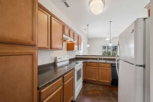 a kitchen with stainless steel appliances granite countertop a sink stove and refrigerator