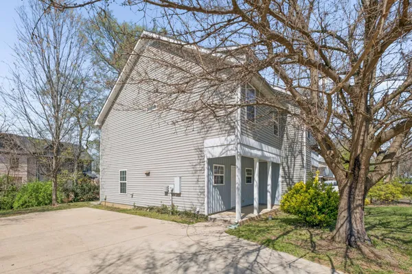 a view of house with a yard