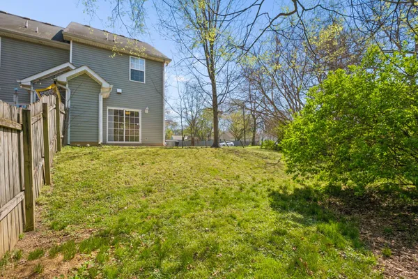 a view of a house with a yard and trees