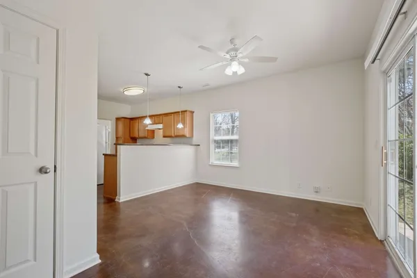 an empty room with window and wooden floor