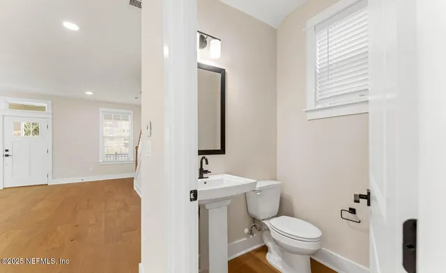 a bathroom with a toilet sink and mirror