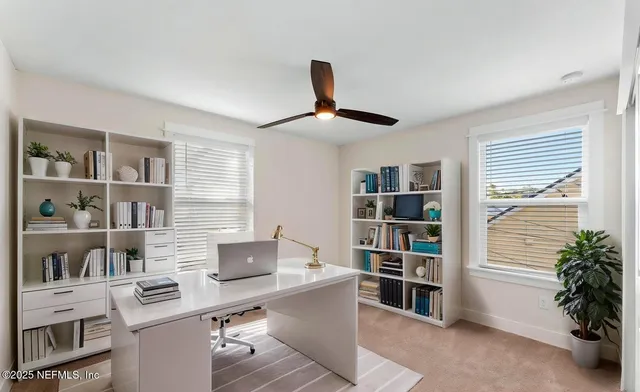 a work room with furniture and book shelf