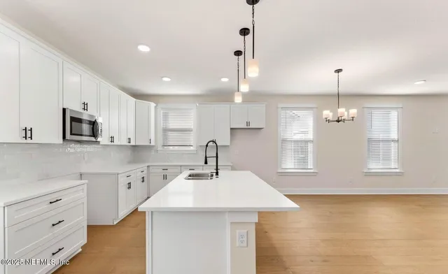 a kitchen with stainless steel appliances granite countertop a sink a stove and a refrigerator