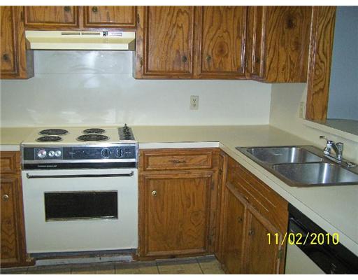 6717 Oakgate Drive Corpus Christi, TX 78413 - Photo 4 of 10 a kitchen with granite countertop a sink a stove and cabinets