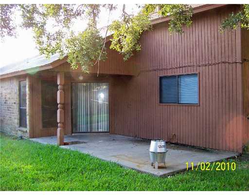 6717 Oakgate Drive Corpus Christi, TX 78413 - Photo 7 of 10 a backyard of a house with table and chairs