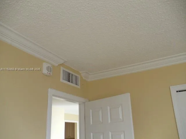 a bathroom with a granite countertop toilet and a sink