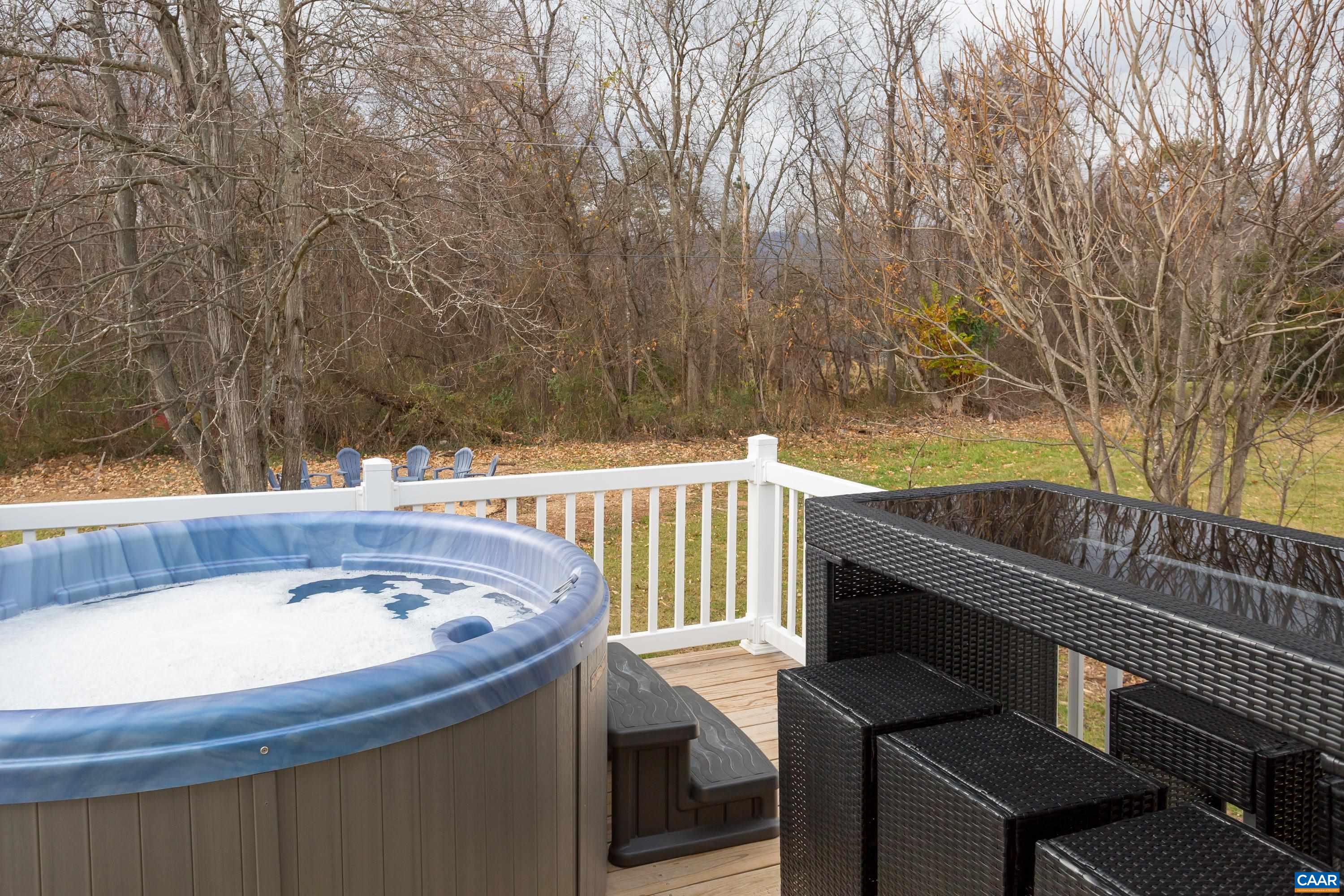 1795 Avon Road Afton, VA 22920 - Photo 31 of 39 a view of a balcony with a table and chairs and a fire pit