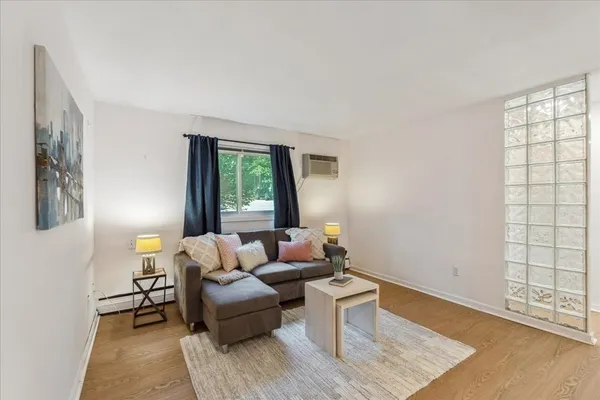 a living room with furniture and wooden floor