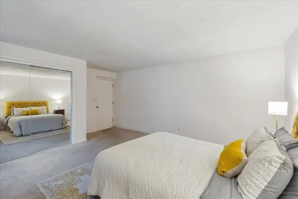 a bedroom with a bed and a couch