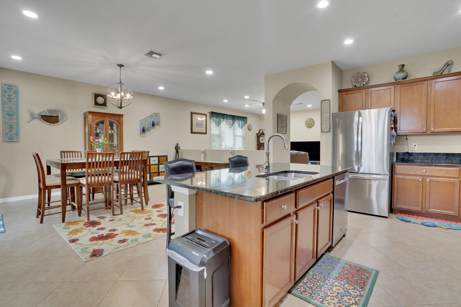212 Behring Way Jupiter, FL 33458 - Photo 19 of 56 a kitchen with stainless steel appliances kitchen island granite countertop a sink and cabinets