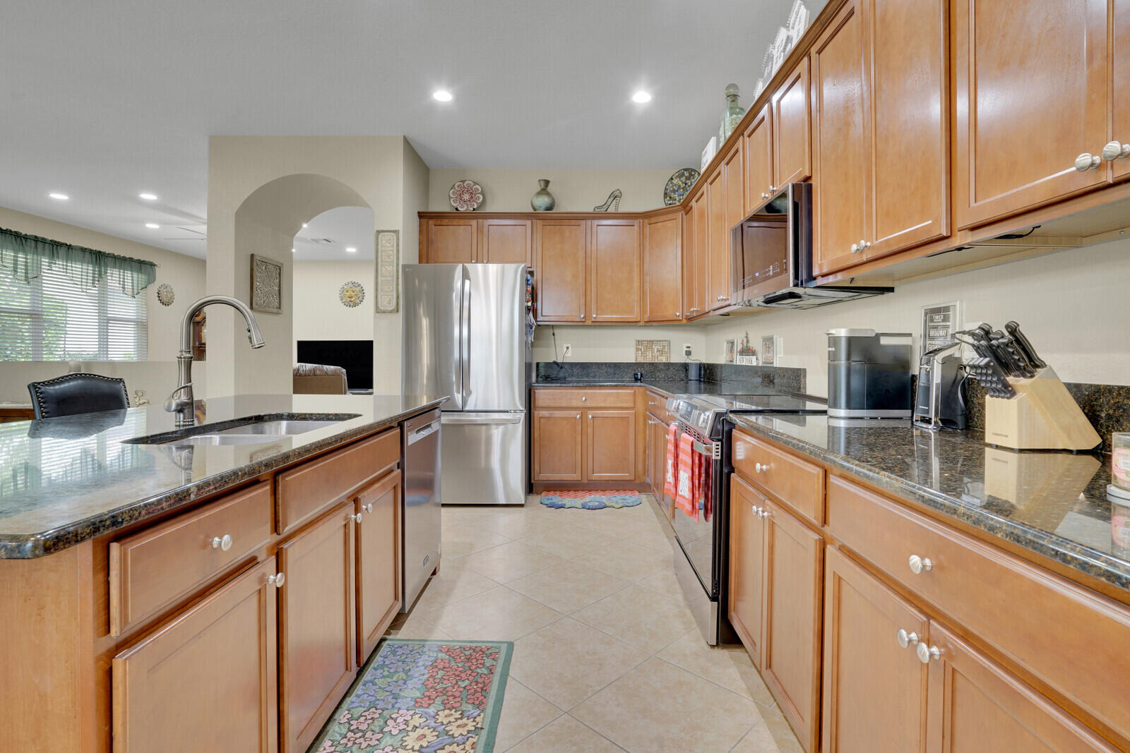 212 Behring Way Jupiter, FL 33458 - Photo 20 of 56 a kitchen with stainless steel appliances granite countertop a sink and cabinets