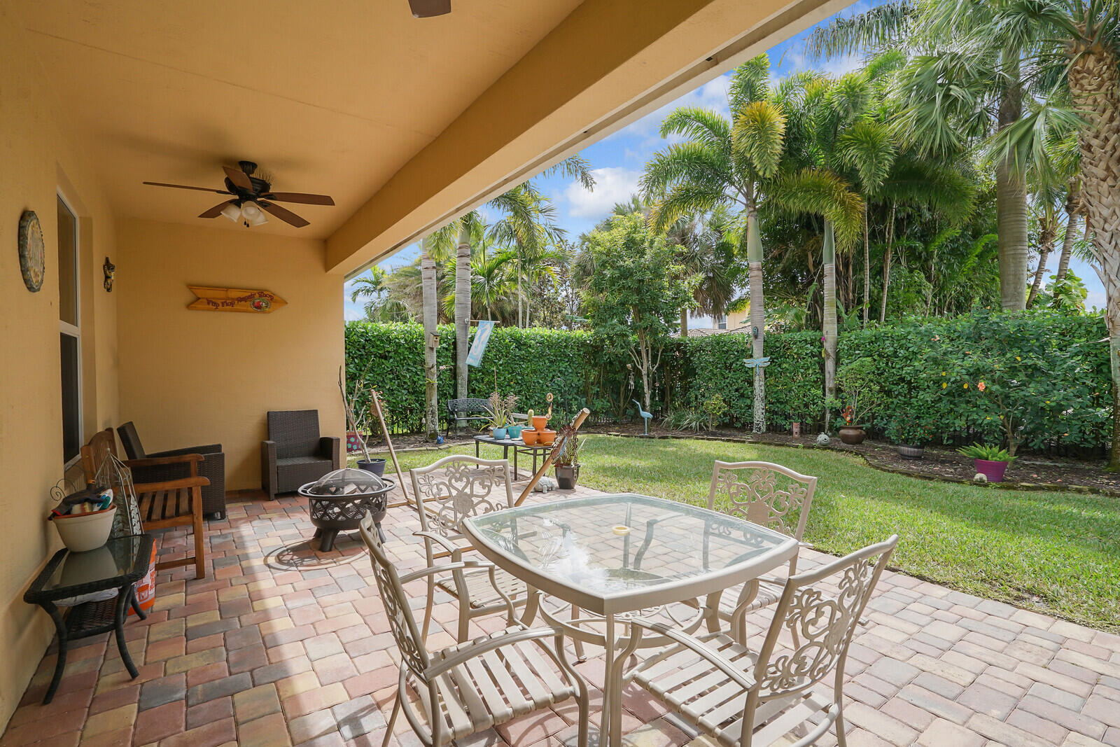 212 Behring Way Jupiter, FL 33458 - Photo 38 of 56 a patio with glass top table and chairs