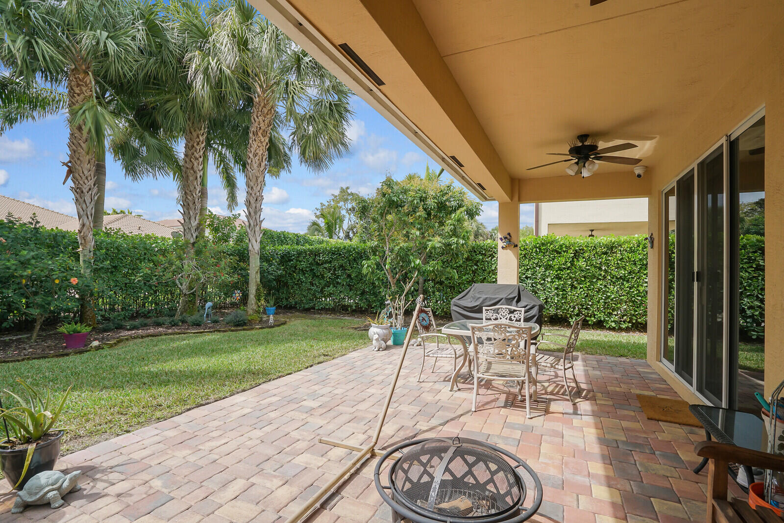 212 Behring Way Jupiter, FL 33458 - Photo 39 of 56 a view of a patio with a table and chairs