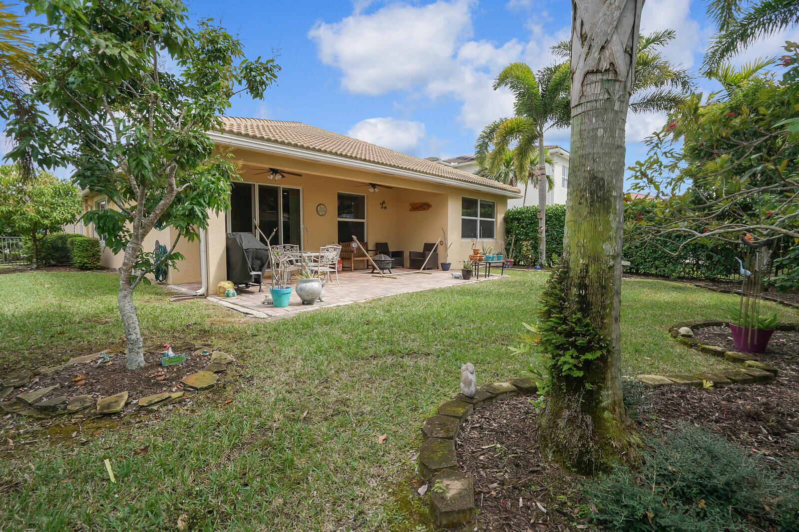 212 Behring Way Jupiter, FL 33458 - Photo 41 of 56 a front view of a house with garden