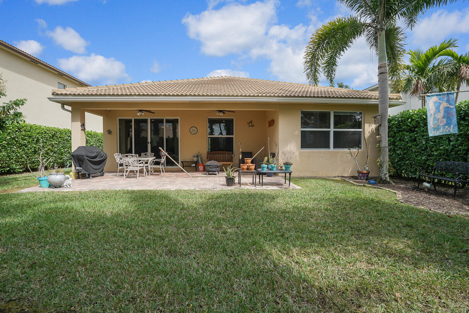 212 Behring Way Jupiter, FL 33458 - Photo 42 of 56 a view of a house with outdoor space and a garden