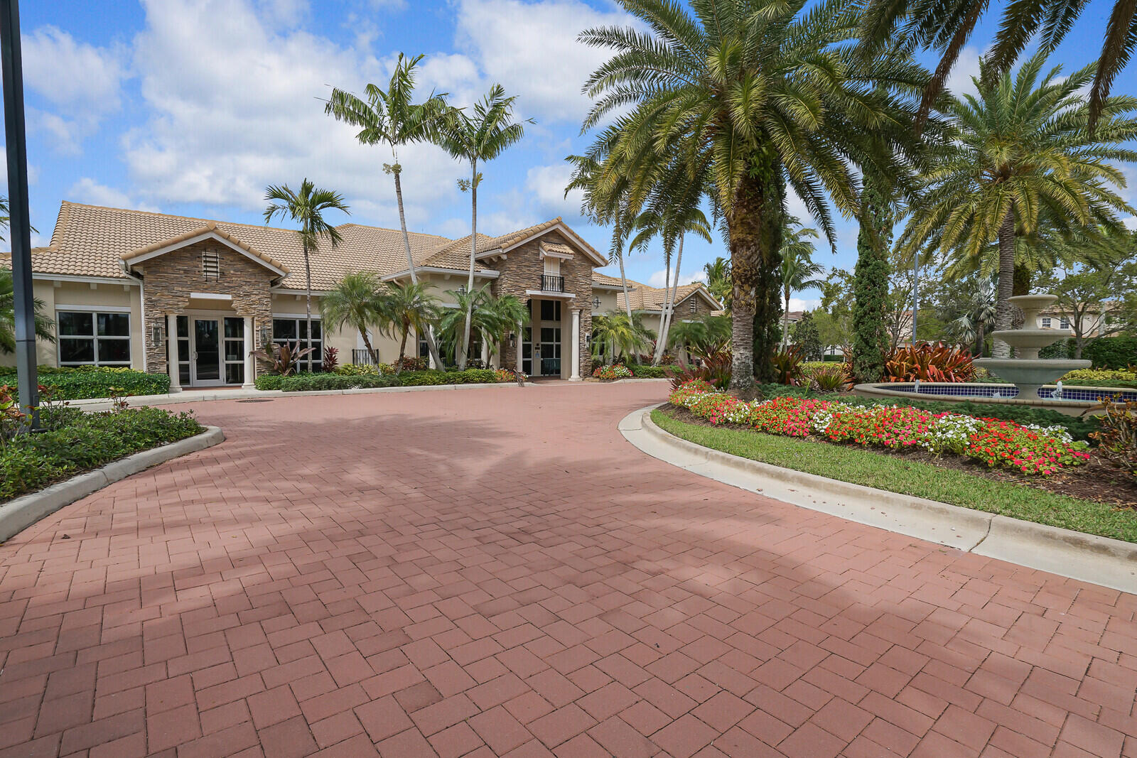 212 Behring Way Jupiter, FL 33458 - Photo 50 of 56 a front view of a house with a garden and a yard