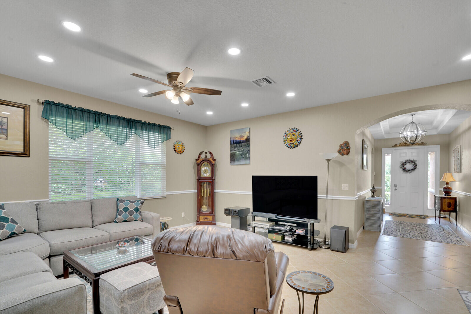212 Behring Way Jupiter, FL 33458 - Photo 6 of 56 a living room with furniture and a flat screen tv