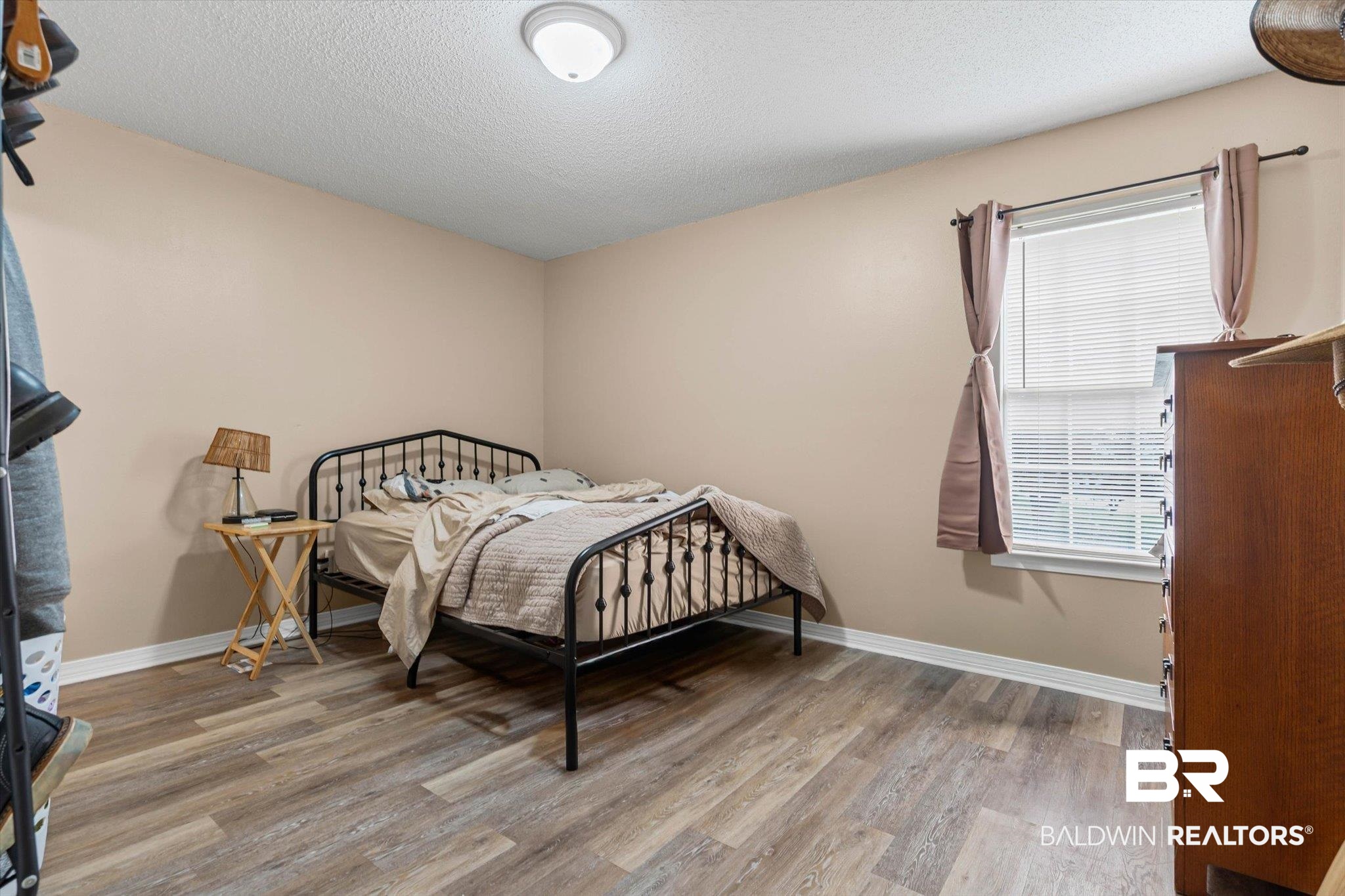 14165 River Oaks Road, Unit A & B Coden, AL 36523 - Photo 10 of 35 Bedroom featuring light wood-style flooring and a textured ceiling