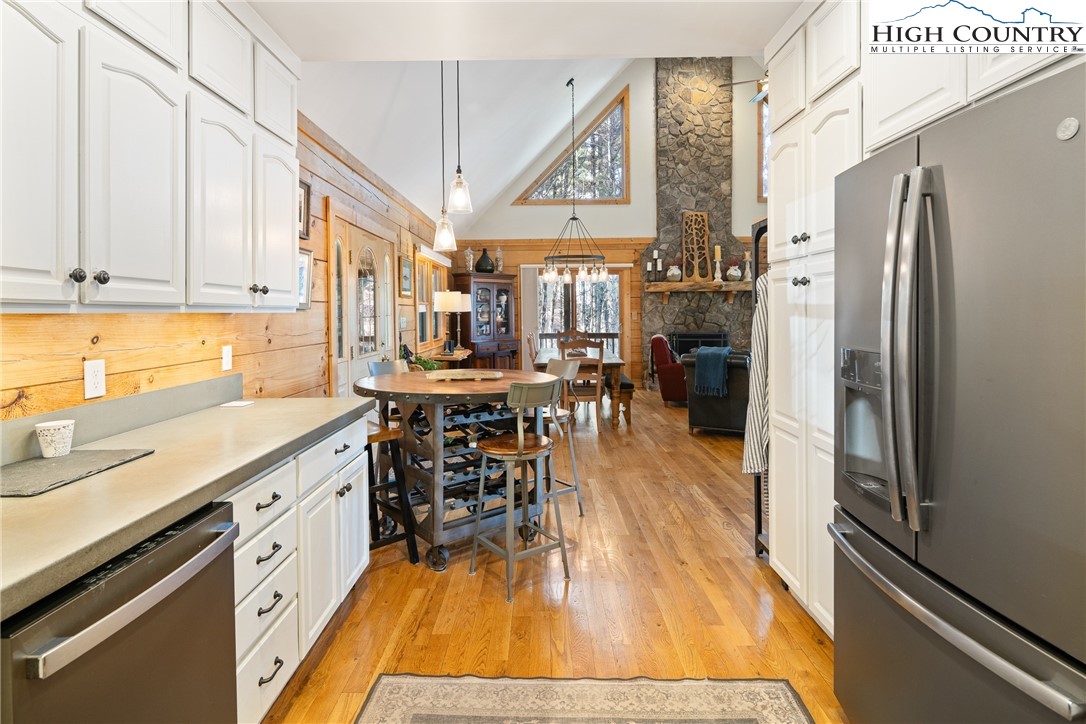 672 Kalmia Lane Boone, NC 28607 - Photo 18 of 41 a kitchen with stainless steel appliances white cabinets and wooden floors