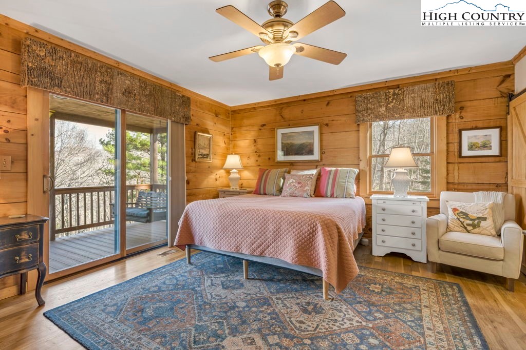 672 Kalmia Lane Boone, NC 28607 - Photo 19 of 41 a spacious bedroom with a bed and a couch