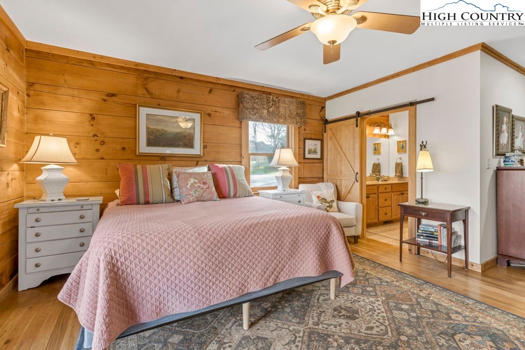 672 Kalmia Lane Boone, NC 28607 - Photo 20 of 41 a bedroom with a bed and wooden floor