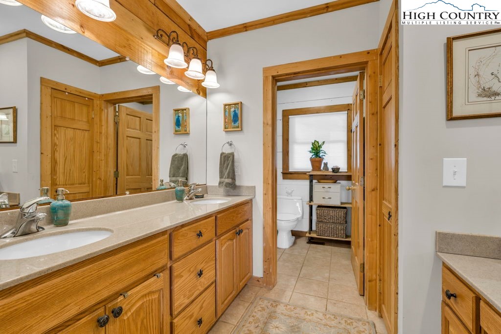 672 Kalmia Lane Boone, NC 28607 - Photo 21 of 41 a en suite bathroom with a granite countertop sink and a mirror