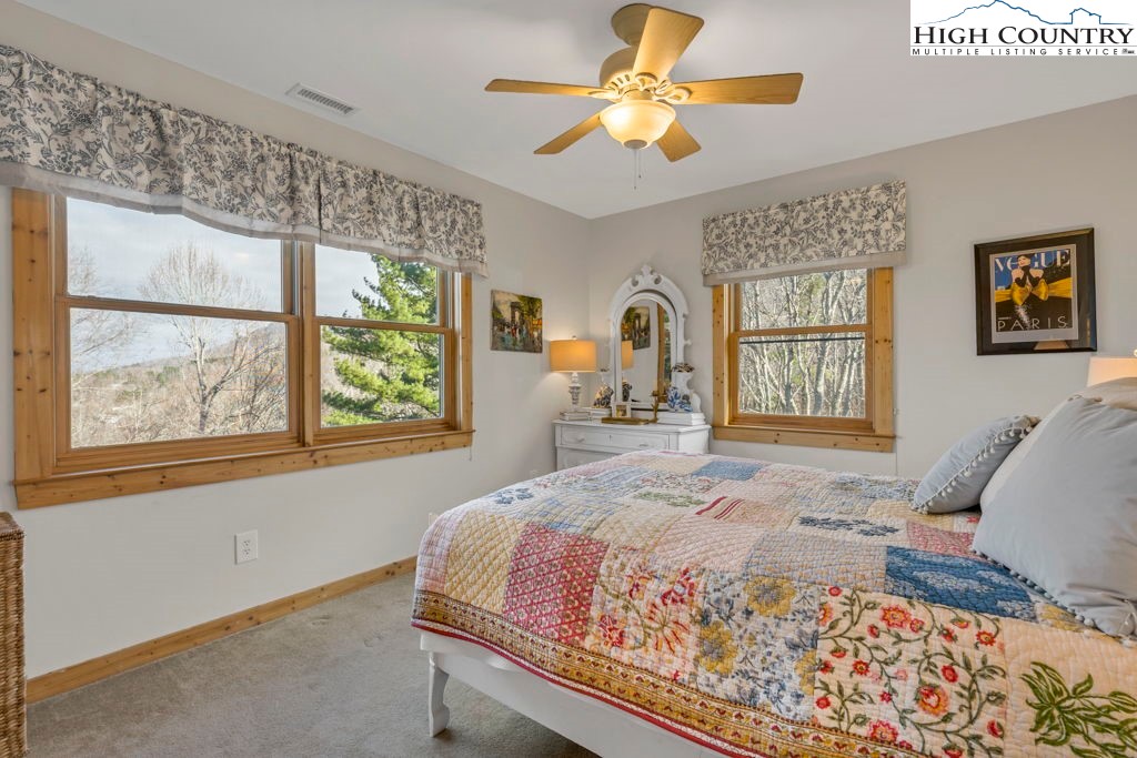 672 Kalmia Lane Boone, NC 28607 - Photo 27 of 41 a bedroom with a large bed and a window