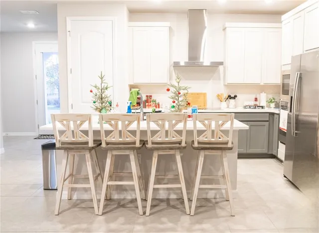 a kitchen with stainless steel appliances a refrigerator and a stove
