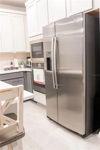 a kitchen with stainless steel appliances granite countertop a sink and a stove