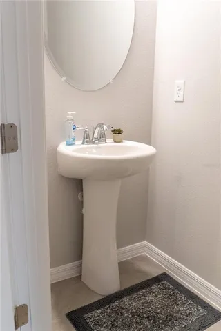 a white toilet sitting next to a white sink