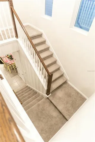 a living room with a bed and next to a window
