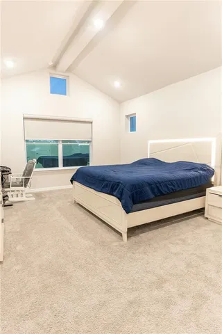 a bed room with a bed and a chair