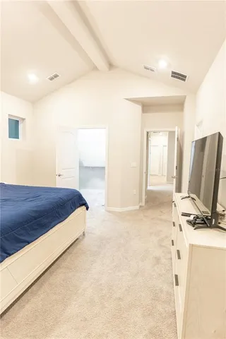 a bedroom with a bed and flat screen tv
