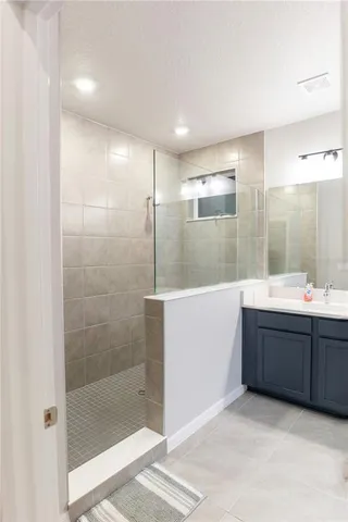 a bathroom with a double vanity sink and a mirror