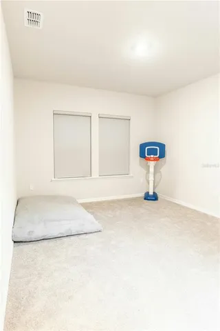 a bedroom with a bed and a cabinet