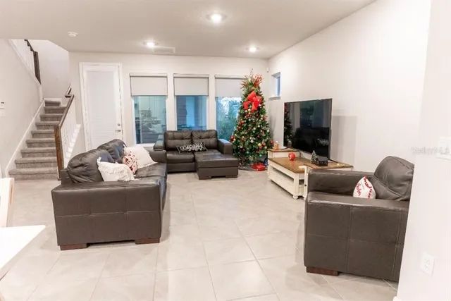 a living room with furniture and a flat screen tv