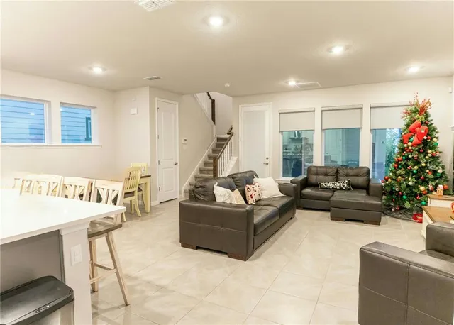 a living room with furniture and flowers