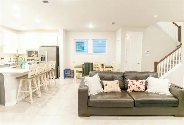 a living room with furniture and a large window