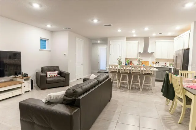 a kitchen with stainless steel appliances kitchen island granite countertop a sink and chairs