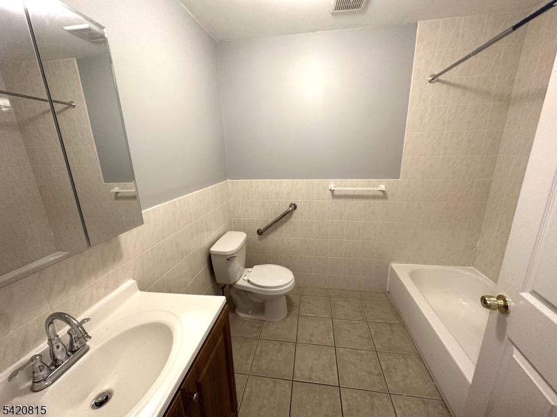 111 Harris Avenue, Unit 5 Middlesex, NJ 08846 - Photo 6 of 6 a bathroom with a sink a toilet and tub