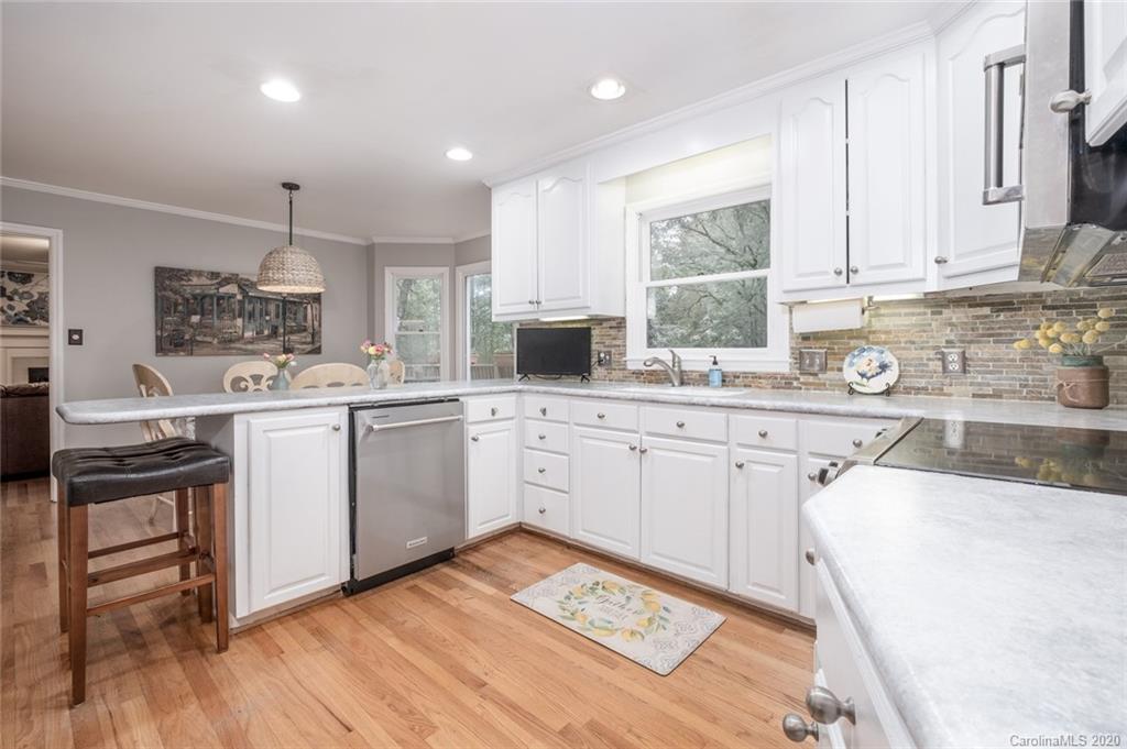 1130 Churchill Road Davidson, NC 28036 - Photo 11 of 38 a kitchen with white cabinets sink and appliances