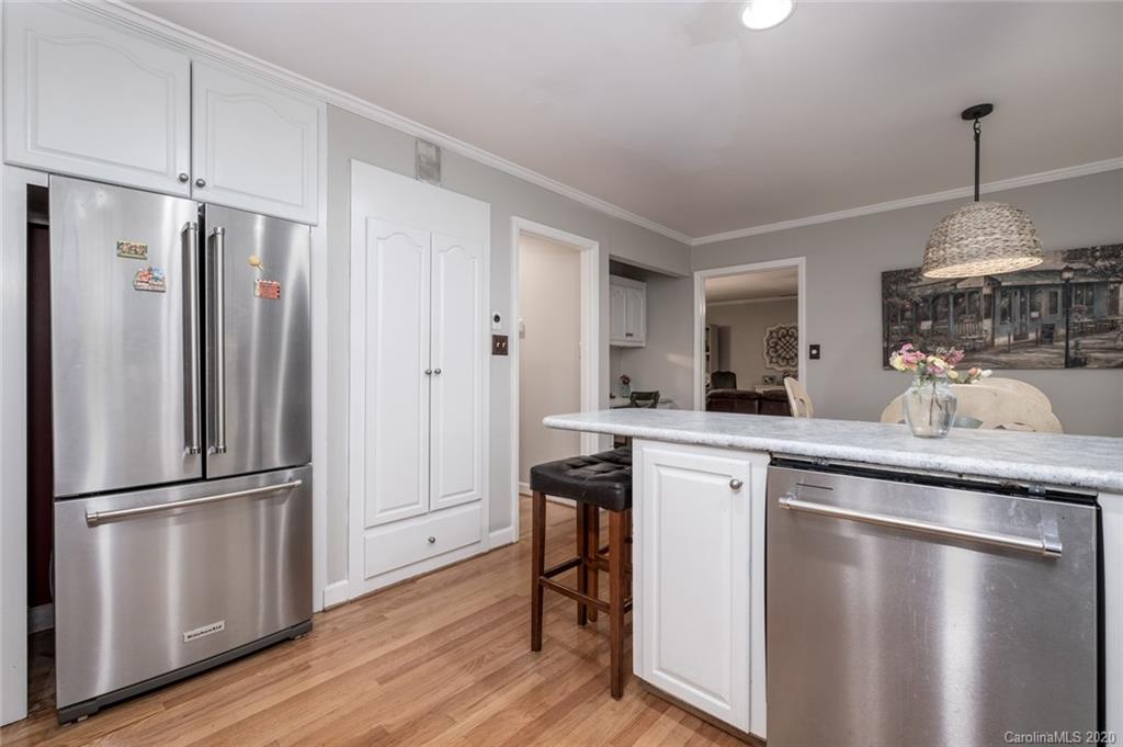 1130 Churchill Road Davidson, NC 28036 - Photo 12 of 38 a kitchen with stainless steel appliances granite countertop a refrigerator a sink and white cabinets