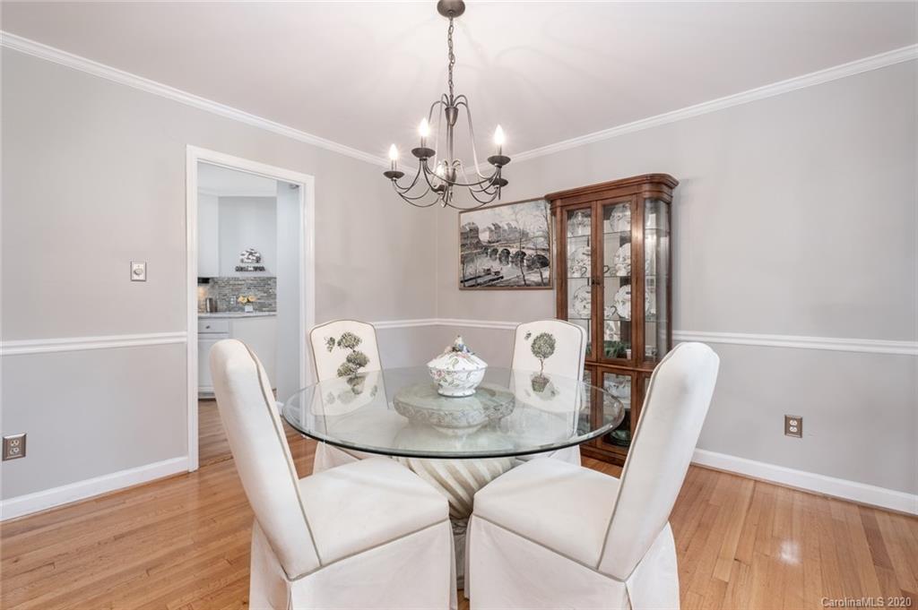 1130 Churchill Road Davidson, NC 28036 - Photo 14 of 38 a dining room with furniture a chandelier and wooden floor
