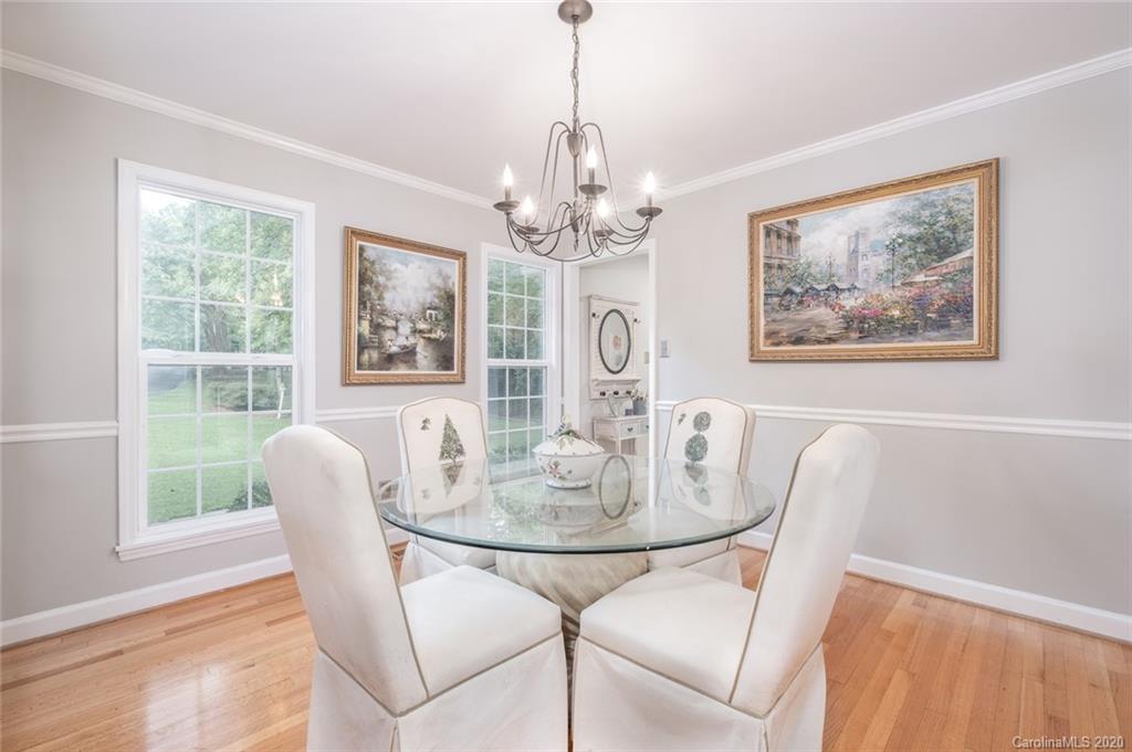 1130 Churchill Road Davidson, NC 28036 - Photo 15 of 38 a dining room with furniture a rug and a chandelier