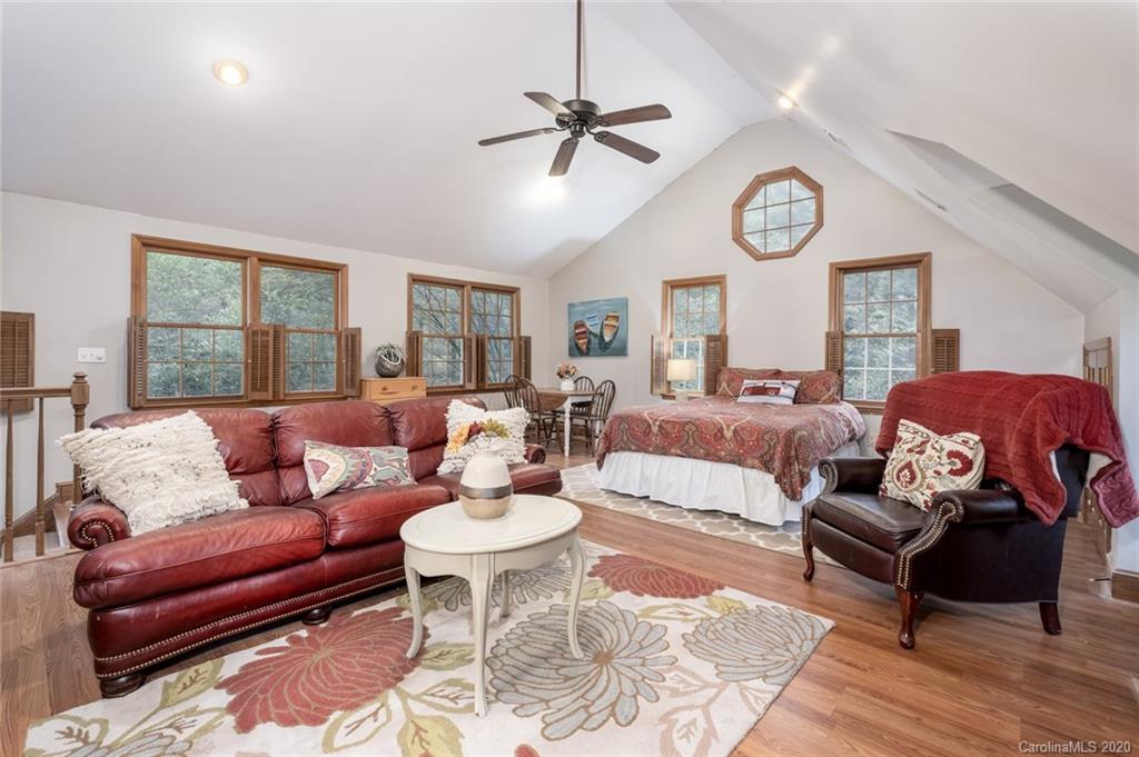 1130 Churchill Road Davidson, NC 28036 - Photo 20 of 38 a living room with furniture a clock on wall and a window