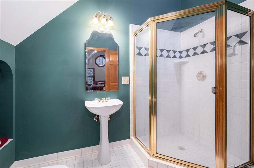 1130 Churchill Road Davidson, NC 28036 - Photo 21 of 38 a bathroom with a sink mirror and a shower