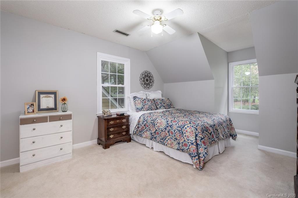 1130 Churchill Road Davidson, NC 28036 - Photo 22 of 38 a bedroom with a bed dresser and a window