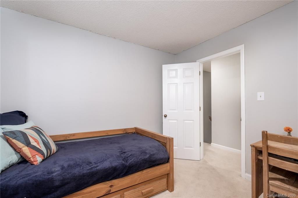 1130 Churchill Road Davidson, NC 28036 - Photo 25 of 38 a bedroom with a bed and cabinets