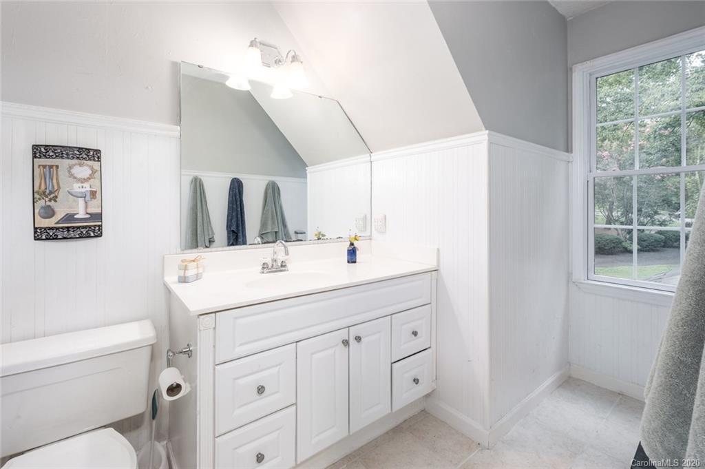 1130 Churchill Road Davidson, NC 28036 - Photo 28 of 38 a bathroom with a sink a toilet and mirror