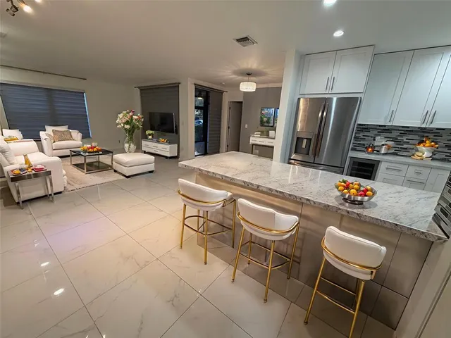 a kitchen with stainless steel appliances a refrigerator and microwave